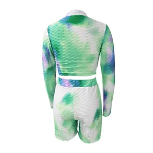 Women tie-dye long sleeve crop top and biker shorts workout two piece athletic set apparel.