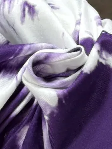 Close-up of purple white tie-dye fabric, showing soft texture and pattern for casual pants.