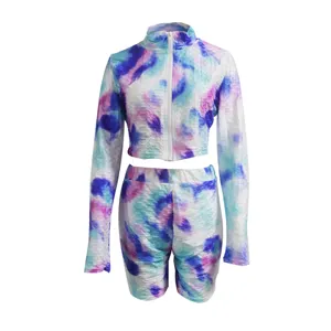 Stylish tie-dye activewear two-piece set, featuring a long sleeve zip crop top and matching shorts.