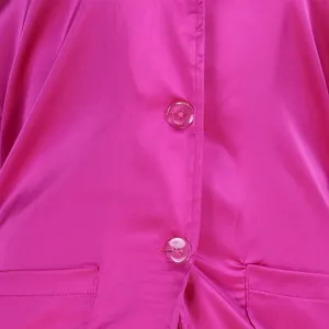 Pink satin shirt front detail, showing glossy fabric, buttons, and pocket design.