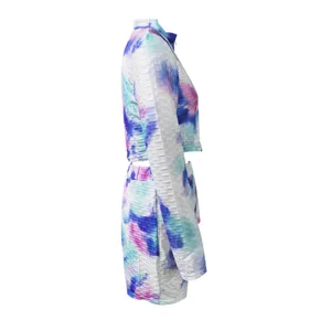 Tie-dye activewear set detail showcasing textured long sleeve crop top and matching shorts.