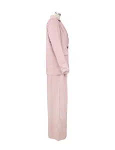 Side detail view of women casual loose pink blazer and pants two-piece suit outfit.