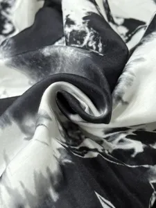 Detailed view of black and white tie-dye fabric texture for stylish casual women trousers.