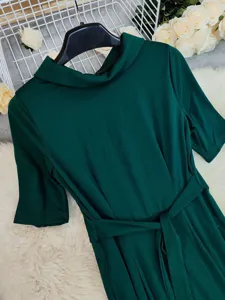 Dark green lapel half sleeve wide leg jumpsuit with waist belt, elegant spring women's fashion.