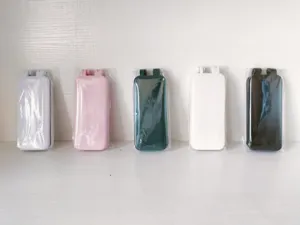 Portable folding lint remover detail view, compact travel clothes fuzz shaver in multi colors.