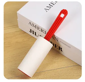 Detailed view of the red and white lint roller, perfect for effortlessly cleaning clothes.