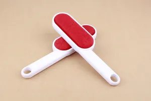 Double-sided lint remover brush for clothes, red and white ABS handle dust cleaning tool for daily use.
