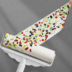 Detailed close-up view of the large lint roller with tear-off sticky sheets and colorful paper.