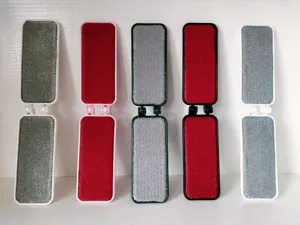 Double-sided foldable lint remover brush for clothes, portable static pet hair removal tool.