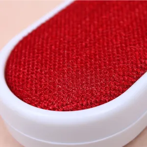 Red fabric lint brush detail close-up showing electrostatic dust removal texture and white frame