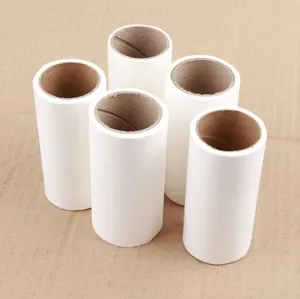 Close-up detail of white lint roller refill paper rolls with sturdy brown cardboard cores.