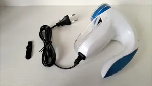 Electric lint remover fabric shaver for clothes with power cord and practical cleaning brush.