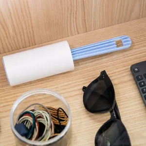 Portable sticky lint roller with folding handle for easy dust and hair removal on clothes.