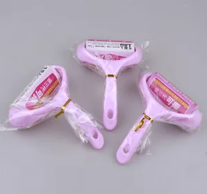 Detailed view of pink lint rollers with adhesive paper rolls and clear protective packaging.