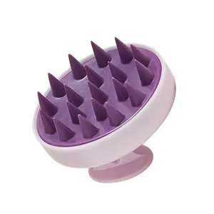 Silicone scalp massage shampoo brush with soft conical bristles and convenient suction cup base.