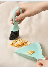 Compact green mini brush and dustpan set for desktop and keyboard cleaning, useful home tool.