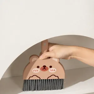 Mini desktop broom and dustpan set, cute brown bear design, compact cleaning tool for desk.