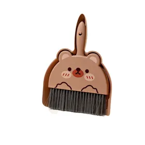Mini desktop broom and dustpan set, cute brown bear design, perfect desk cleaning tool.