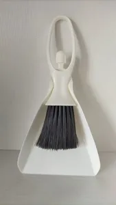Mini desktop broom and dustpan set detail, creative cleaning brush for keyboard and drawer.