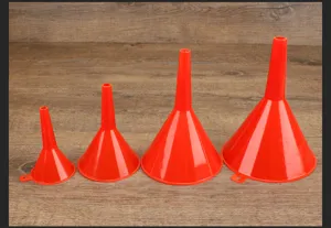 Red plastic funnel detail showing the four different sizes arranged neatly on wood texture.
