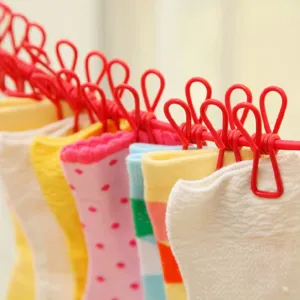 Portable outdoor clothesline with 12 colorful clips and socks, windproof elastic drying rope.