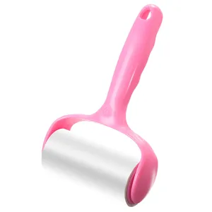 Pink plastic handle lint roller with tearable sticky paper for clothes cleaning and dust removal.