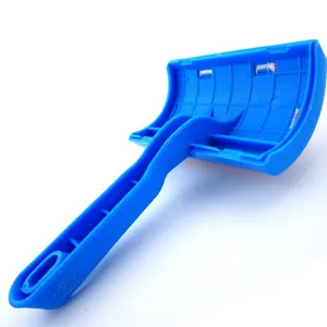 Blue plastic pet fur care brush detail view, showing ergonomic handle and back rib design.