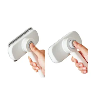 Portable manual pet cleaning brush with push button white and grey for home use daily.