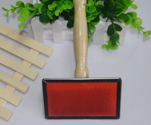 Pet slicker brush detail view featuring a smooth wooden handle and fine stainless steel pins