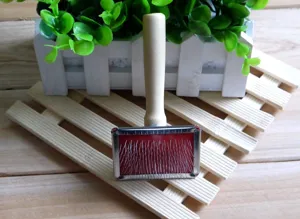 Close up detail of wooden handle pet slicker brush with stainless steel pins for grooming hair.