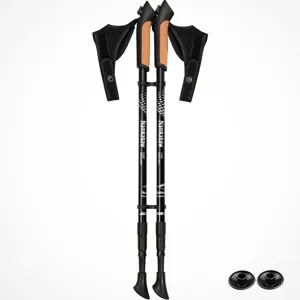 Detailed view of black aluminum trekking poles with cork grips and adjustable sections.