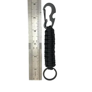 Black paracord keychain with metal carabiner and bottle opener, outdoor survival gear.