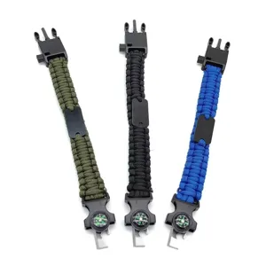 Outdoor survival paracord bracelet with compass, fire starter, and whistle for camping and hiking.