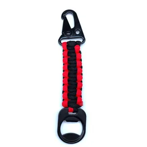 Detail view of the black and red paracord keychain featuring a snap hook and bottle opener.