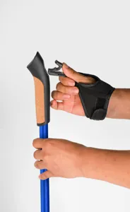 Adjustable aluminum trekking pole with ergonomic cork handle and quick-release strap system.