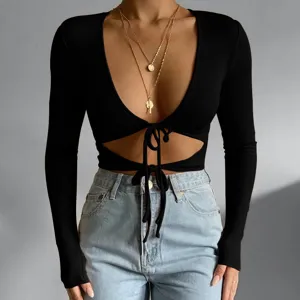 Black long sleeve crop top, deep v-neck, front cutout with drawstring tie, ribbed knit.