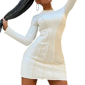 Detailed shot of women's long sleeve bodycon dress featuring stylish exposed seam design.