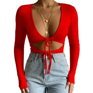 Red long sleeve crop top detail view, featuring a deep V neck and sexy front tie design.