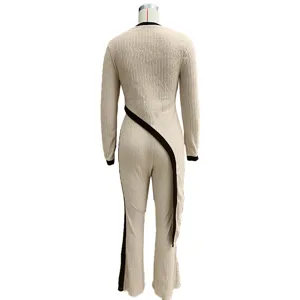 Detail view of women's casual long sleeve jumpsuit with stylish asymmetrical black contrast stripe.