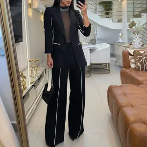 Elegant black and white contrast suit set for women, featuring a chic blazer and wide-leg trousers.