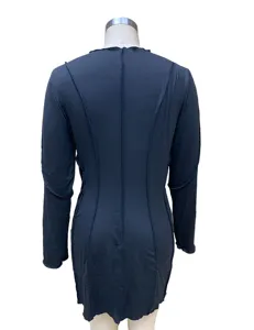 Back detail of a solid color long sleeve bodycon dress featuring exposed seam lines.