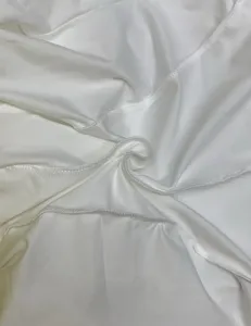 Close up detail of white fabric and stitching for stylish long sleeve bodycon dress.