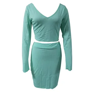 Mint green ribbed two-piece set featuring a v-neck long sleeve crop top and matching mini skirt.