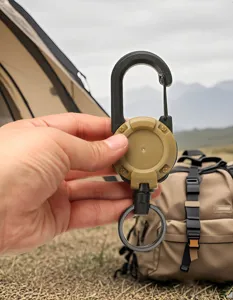 Outdoor retractable carabiner keychain with steel wire cord for camping gear and keys use.