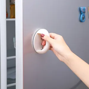 Punch-free adhesive round door handle for cabinet, drawer, and furniture pull convenience.
