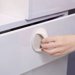 Punch-free adhesive drawer handle white circular cabinet pull for home furniture use.