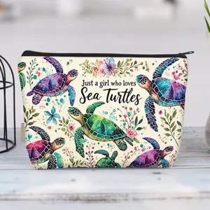 Detailed view of the vibrant sea turtle print on a high-quality canvas makeup bag.
