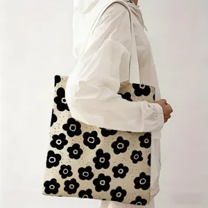 Vista detallada del producto de un bolso de lona grande con estampado floral negro