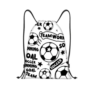 Close-up view of the black soccer ball and star pattern print on a white drawstring bag