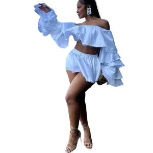 Detailed view of the stylish white two-piece set featuring dramatic ruffled off-shoulder sleeves.